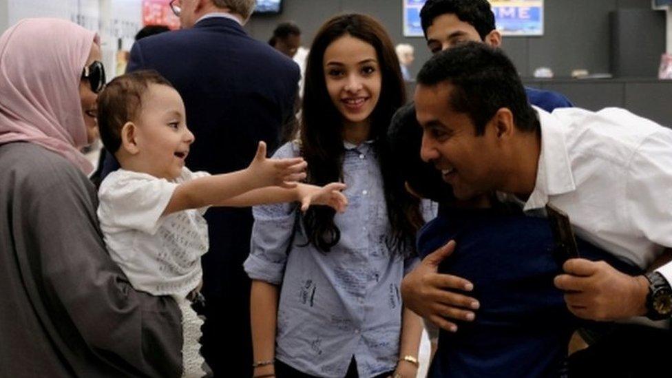 A family hug each other at Washington Dulles Airport on 26 June, 2017, after the U.S. Supreme Court granted parts of the Trump administration's emergency request to put its travel ban into effect