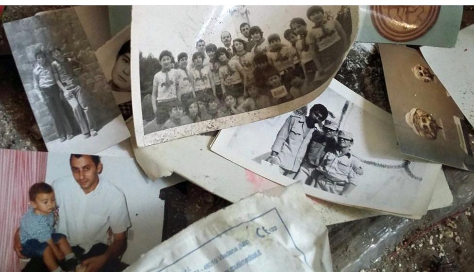 Among the debris there are many family photographs