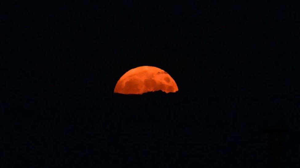 Here the moon is seen rising over the eastern city of Kramatorsk in Ukraine.