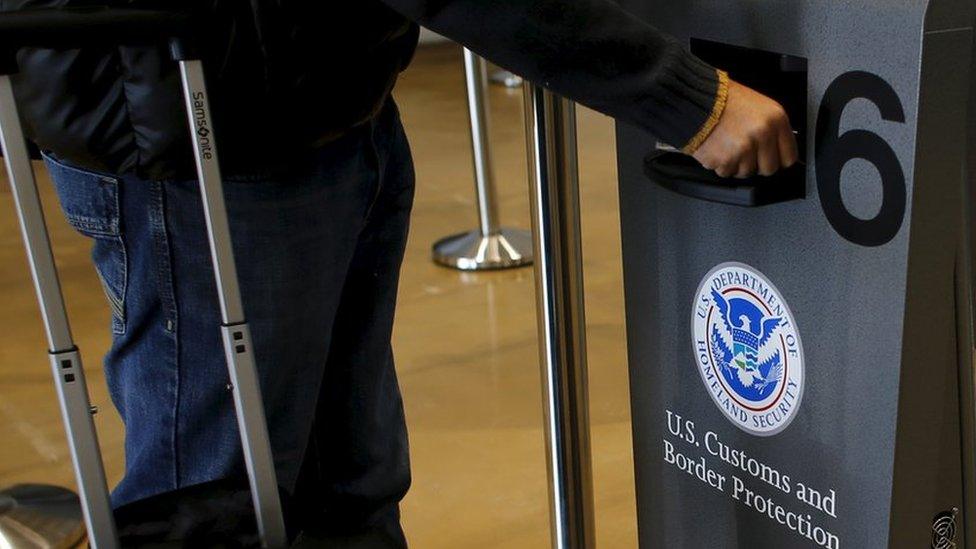 A traveler has his passport scanned as he passes through U.S. Customs and Immigration after using the Cross Border Xpress pedestrian bridge between San Diego and the Tijuana airport on the facility"s opening day in Otay Mesa, California December 9, 2015.