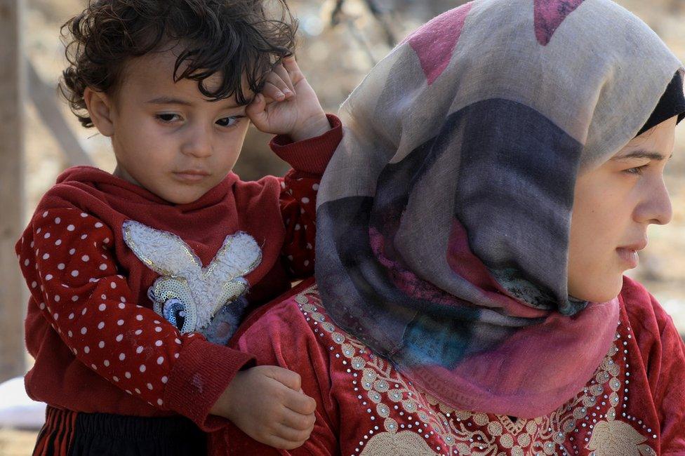 Duaa Filfel and her son on the beach in Deir al-Balah