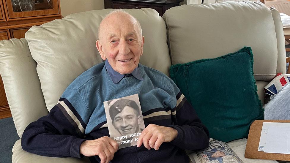 Joe Randall holding a copy of his autobiography