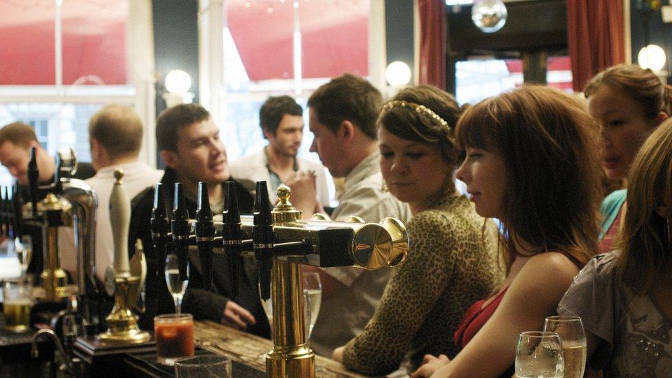 group stands at bar