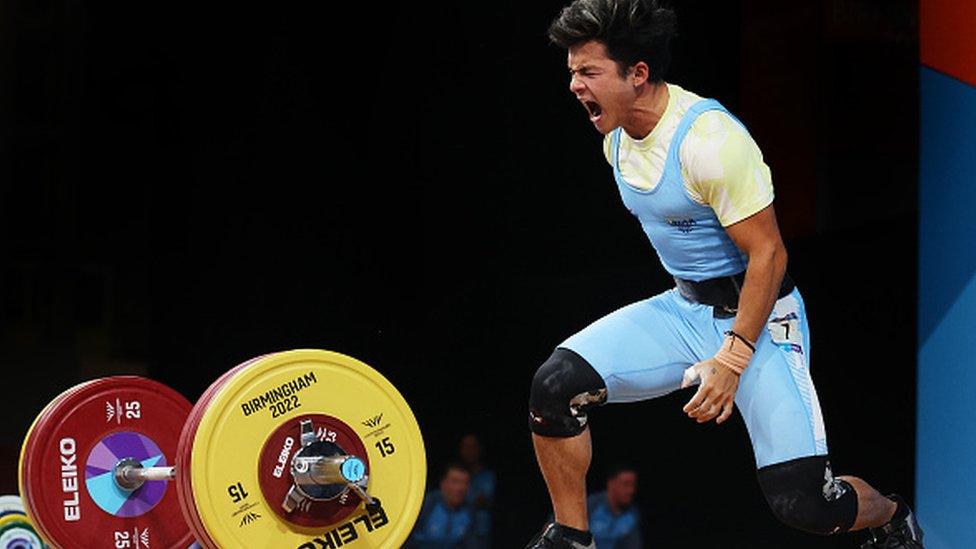 Jeremy Lalrinnunga of Team India reacts after performing a clean & jerk during Men's 67kg Final