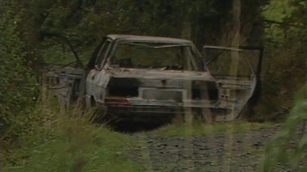 A burnt-out car that was found after the shooting