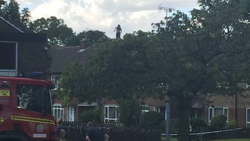 Man, Kyle Ferguson, on rooftop of a house