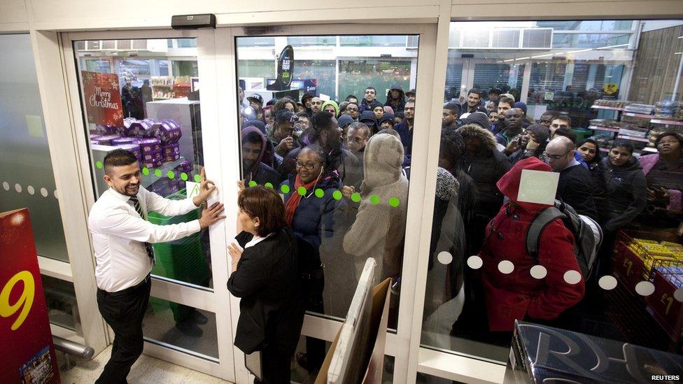 People queuing outside a supermarket