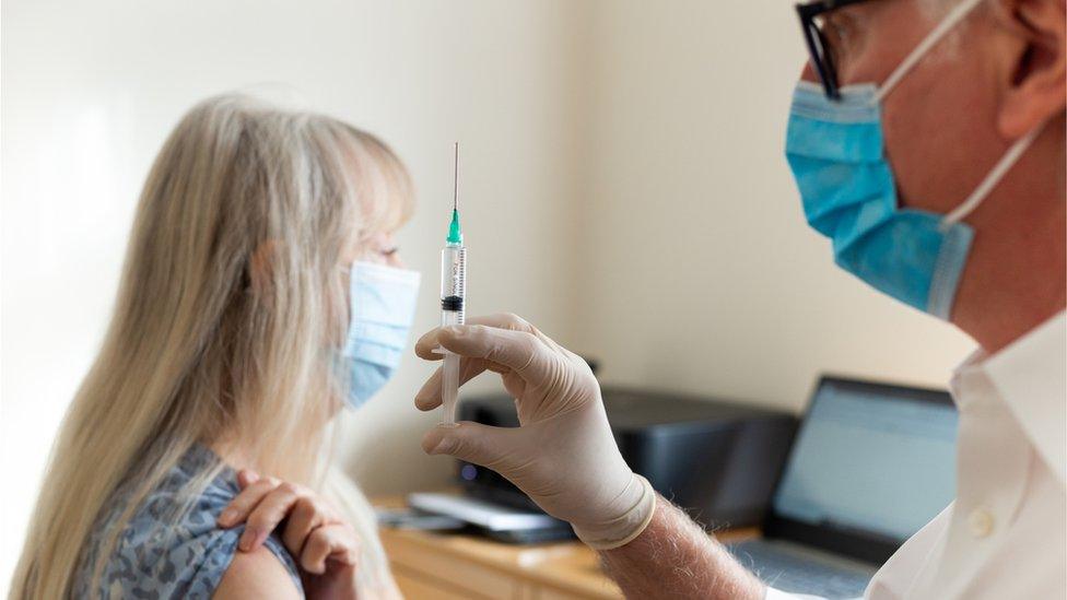 Older woman being vaccinated