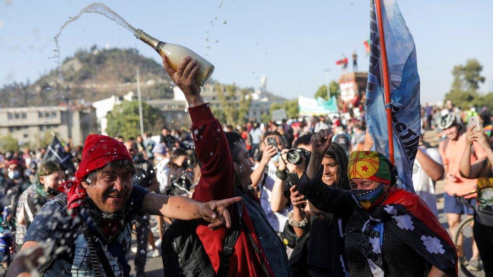 People participate in a demonstration after Lucia Hiriart, the widow of Former Chilean dictator Augusto Pinochet, passed away, in Santiago