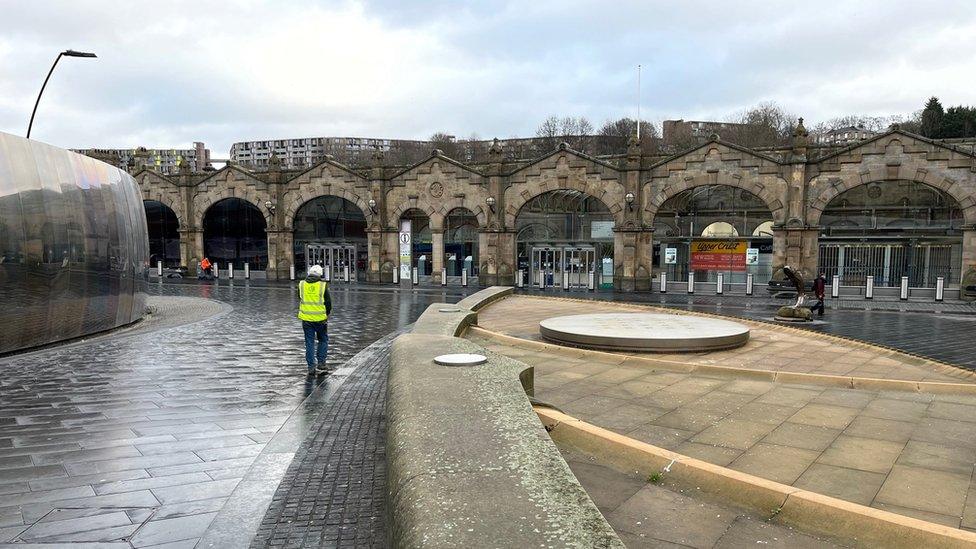 Person with high-vis vest walking towards Sheffield station