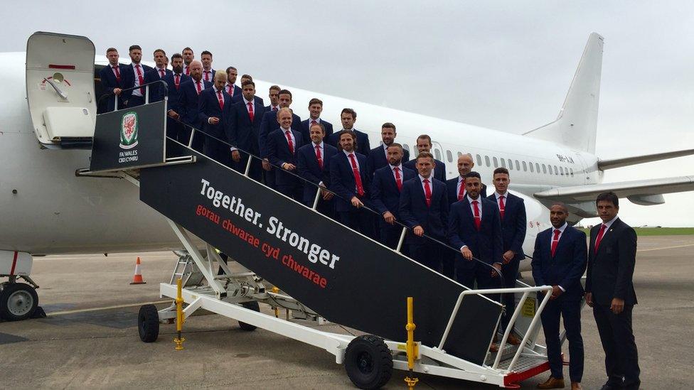 The Welsh team boards the plane