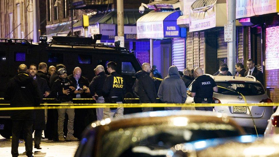 Police secure and investigate the scene of a shooting in Jersey City