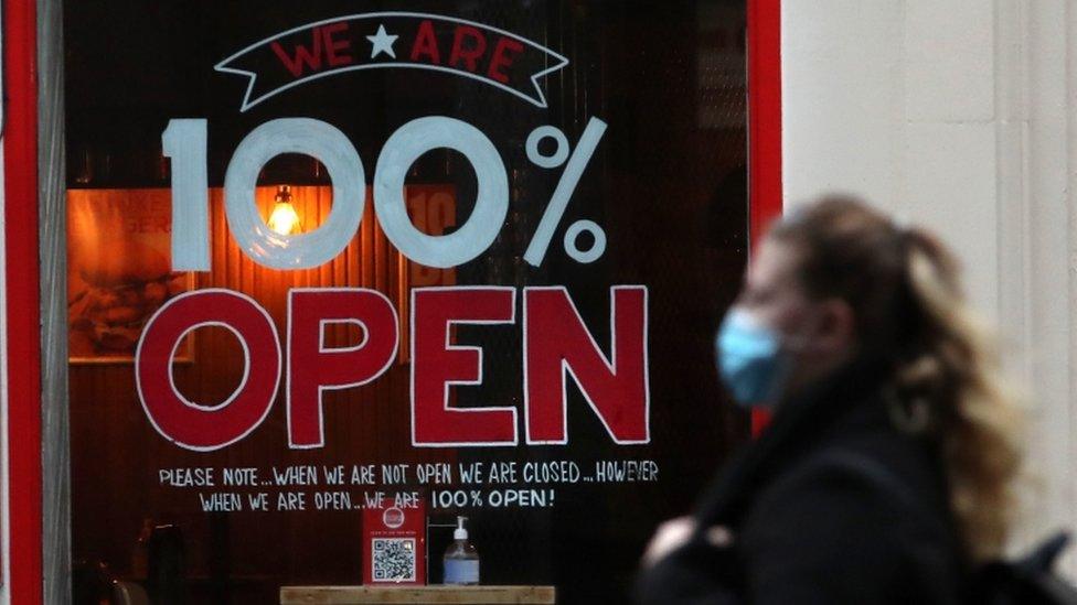 woman walking past restaurant in Glasgow