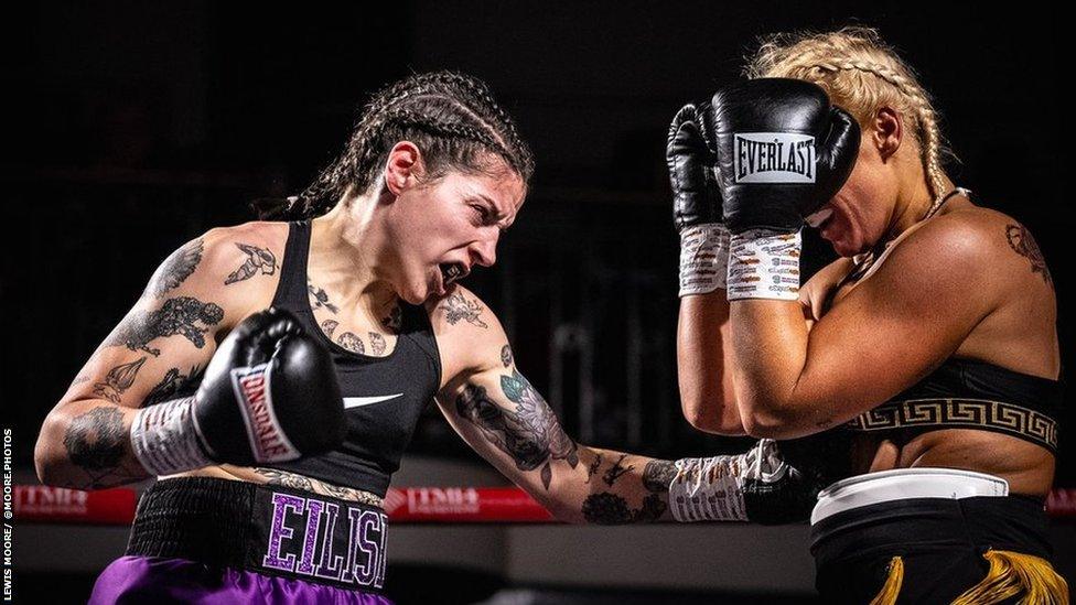 Eilish Tierney in her purple shorts, black vest mid punch in her fight.