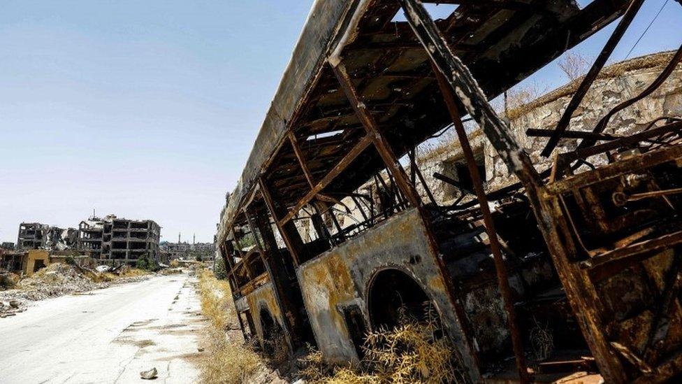 A burnt out bus in Aleppo, Syria