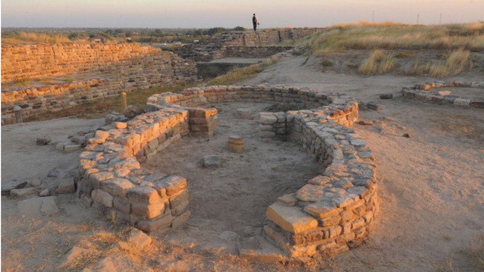 A tourist explores the ancient Dholavira archelogical site in Kachchh district in Gujarat state on December 18, 2011. Dholavira has emerged as a major Harappan city remarkable for its exquisite town planning, monumental structures, aesthetic architecture and amazing water management and storage system. Dholavira excavated site is maintained by the Archaeological Survey of India