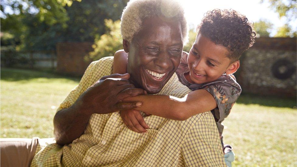 child hugging grandparent