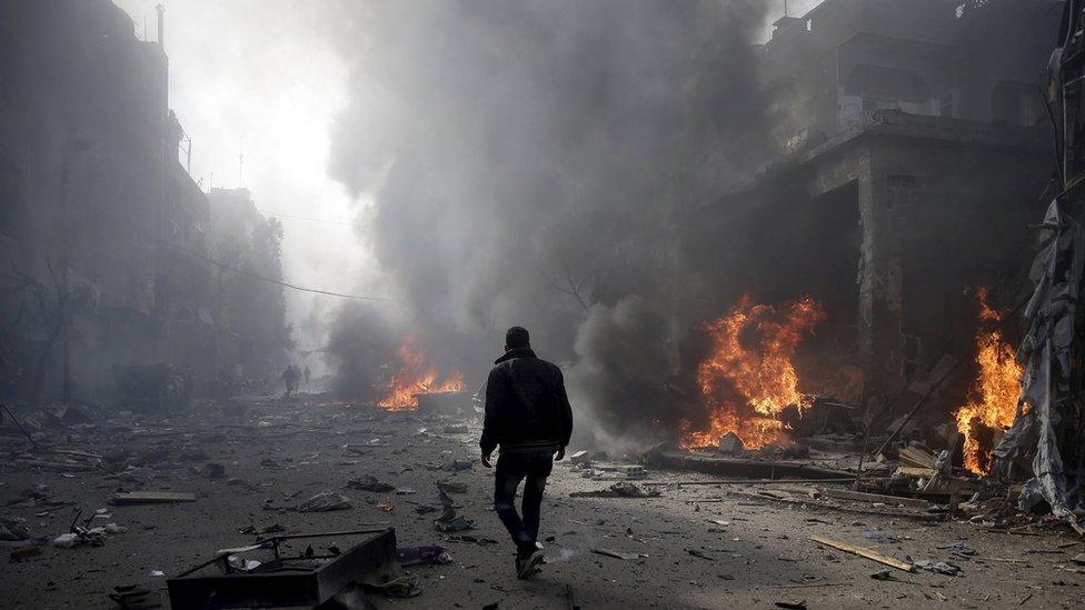 A man inspects a site hit by what activists said were airstrikes by forces loyal to Syria"s President Bashar al-Assad, in the Douma neighborhood of Damascus, Syria