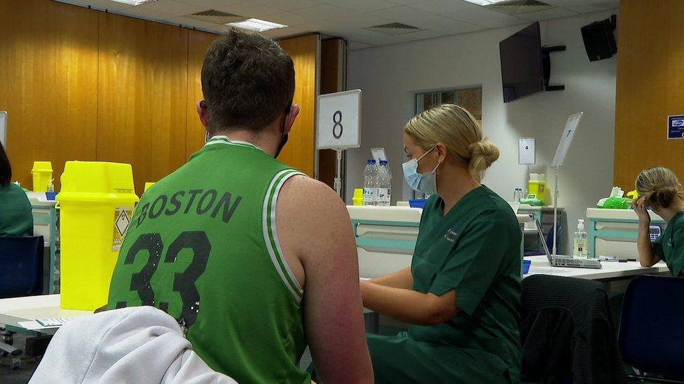 student nurse administering the Covid vaccine