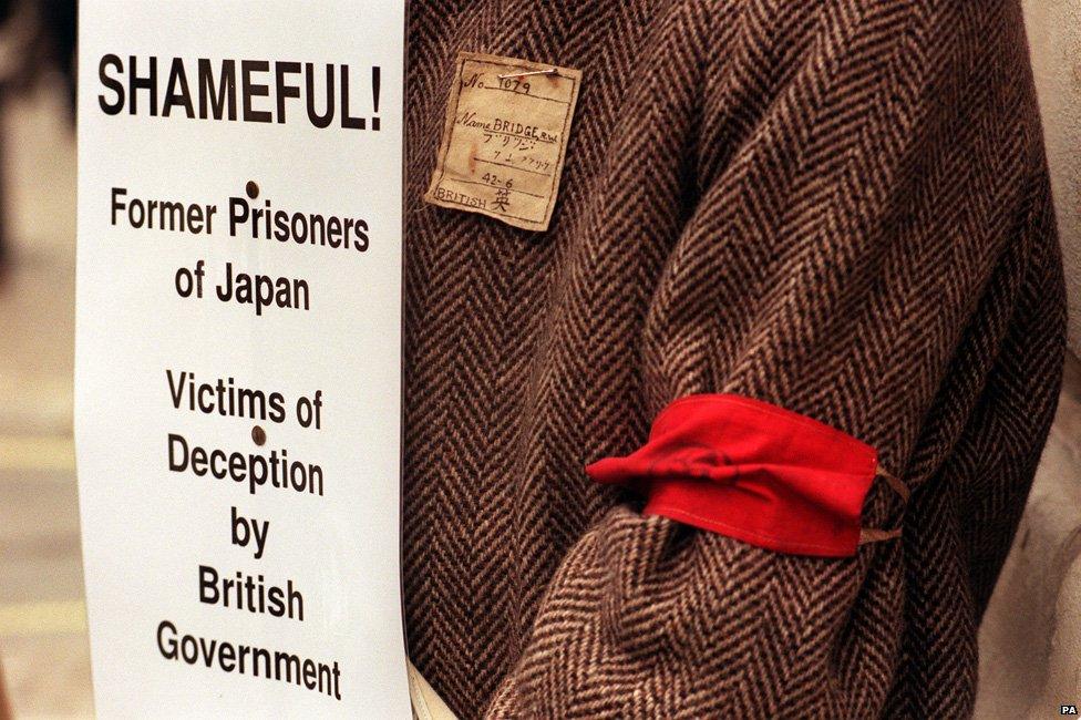 A former PoW demonstrates at the Foreign Office in London, where the ex-PoWs & civilian internees of the Japanese army accused past British governments of lying by falsely insisting they had no legal grounds for claiming further compensation from their captors.