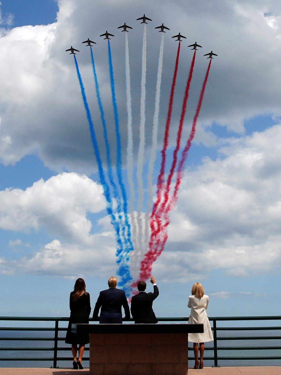 President Trump First Lady Melania Trump, French President Emmanuel Macron and his wife Brigitte Macron watch a flypast in the Normandy American Cemetery