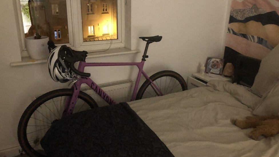 Bike leaning against a bedroom wall