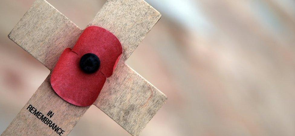 A poppy on a wooden cross