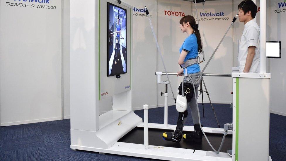 Woman demonstrating the Welwalk WW-1000 robotic brace