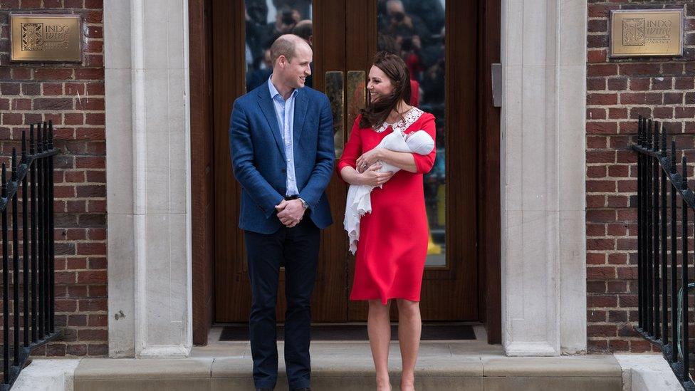 The Duke and Duchess of Cambridge holding their newborn son