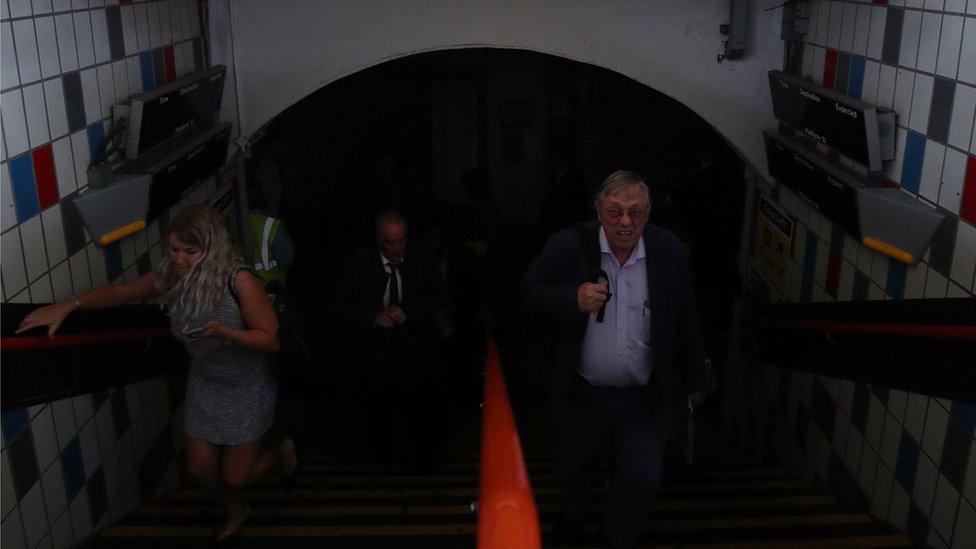 People walking through Clapham Junction station in London during a power cut