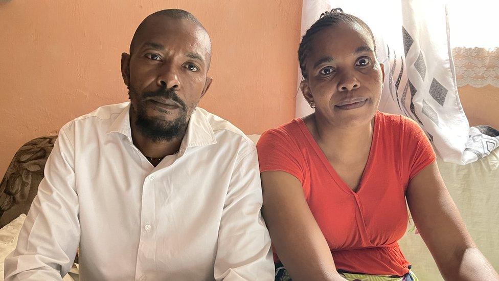 A man and a woman looking into the camera