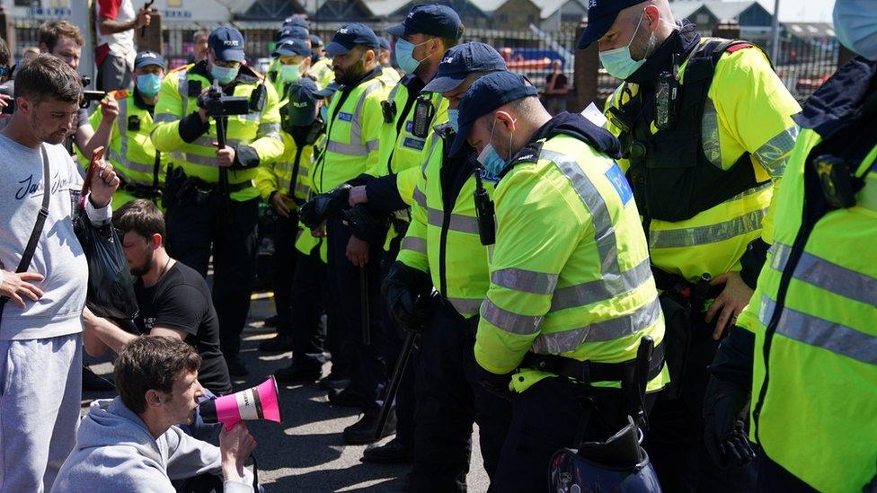 Protesters sit in road