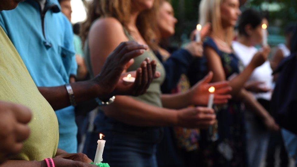 Holding a vigil for the Grenfell Tower fire victims