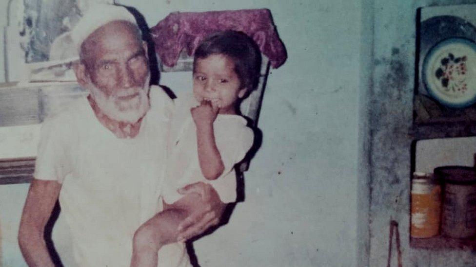 Mohammad Ali with one of his grandchildren