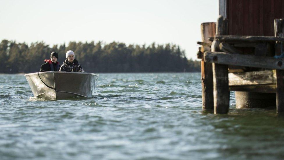 Two people boating on one of Finland's 187,888 lakes