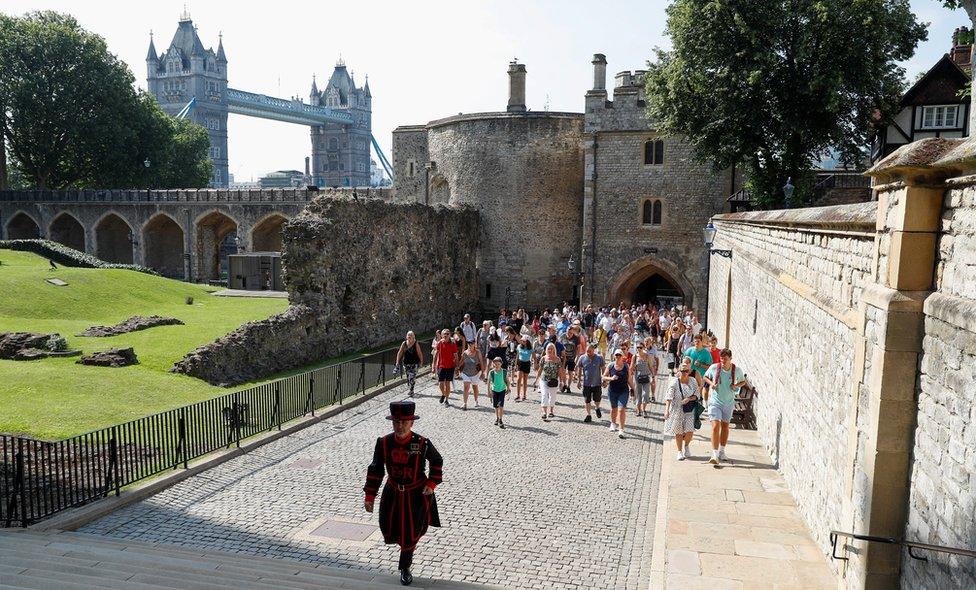 A Yeoman Warder, Barney Chandler leads the first "Beefeater" tour of the Tower of London in 16 months,