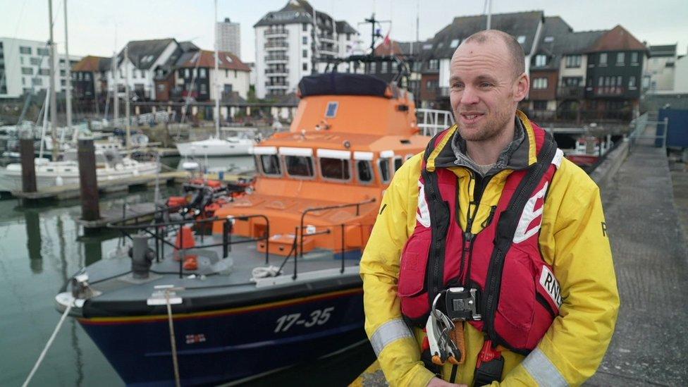 James Scott, RNLI volunteer in front of the Falmouth lifeboat