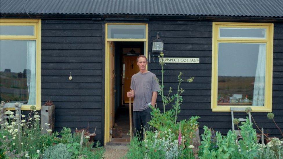 Derek Jarman outside Prospect Cottage