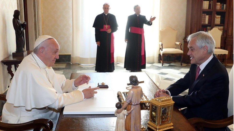 Chile's President Sebastian Pinera (R) listens to Pope Francis (L) as the pontiff receives him in a private audience at the Vatican, 13 October 2018