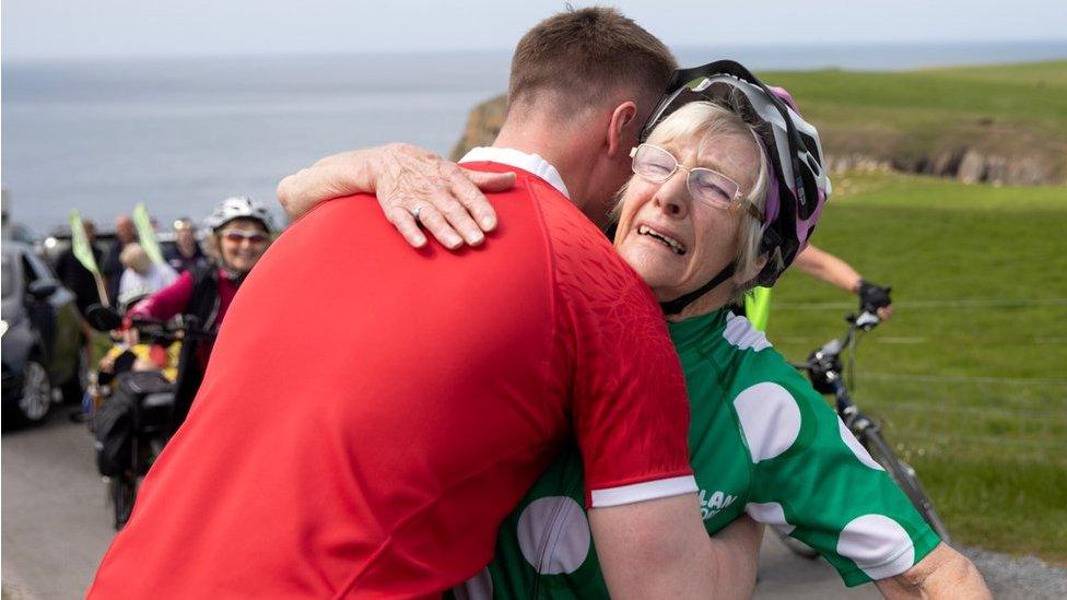 granny mave gets a hug at the finish