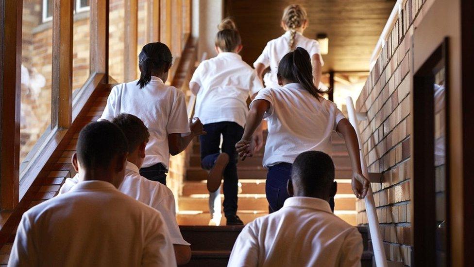 School children running up stairs