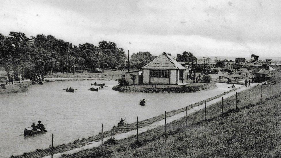 A black and white image of people doing water sports