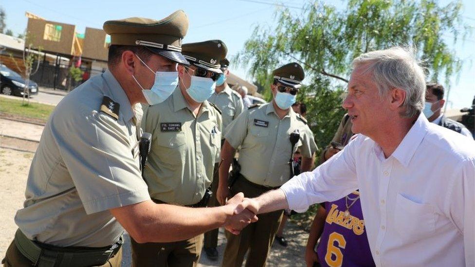 Chilean presidential candidate Jose Antonio Kast from the far-right Republican Party greets policemen during a campaign rally, ahead of the December 19 second round presidential elections, at Calera de Tango area, on the outskirts of Santiago, Chile, November 22, 2021.