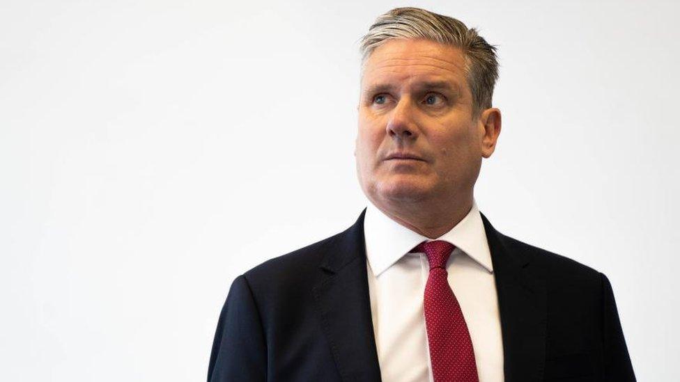 Labour leader Sir Keir Starmer. He is standing in front of a whitewashed wall