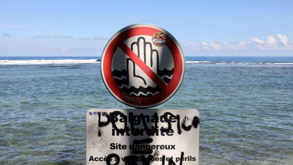 A file photo taken on 25 February, 2010, shows a sign banning swimming at Saint-Leu, on the Indian Ocean island of Reunion