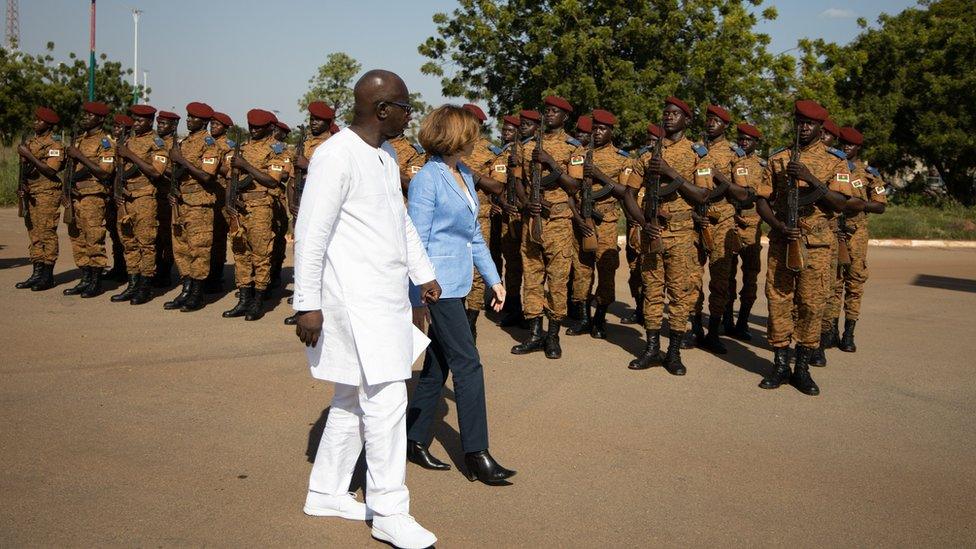 Cherif Sy, Burkina Faso"s Defense Minister (L) and Florence Parly, France"s Defense Minister review the troops during a visit at the Burkinabe minister of Defense in Ouagadougou