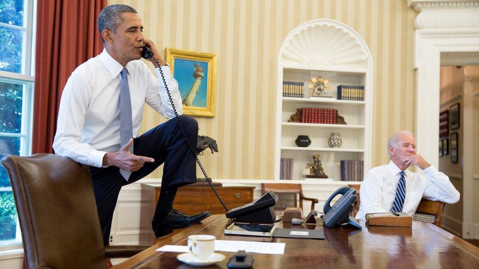 Barack Obama on the phone with Speaker of the House Boehner as Vice President Joe Biden listens in the Oval Office, 31 August 2013