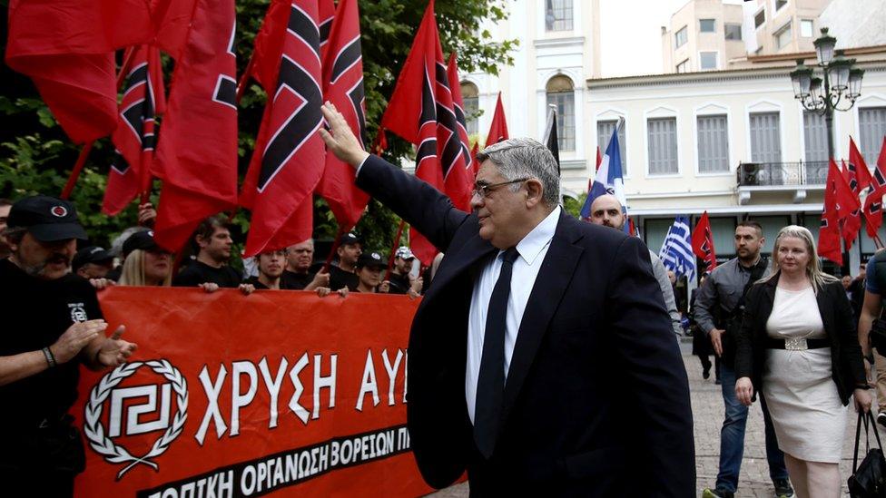 Golden Dawn leader Nikolaos Michaloliakos salutes party supporters in 2017 (file pic)