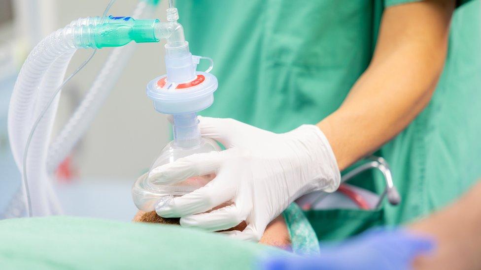 Medical staff treating patient (stock photo)