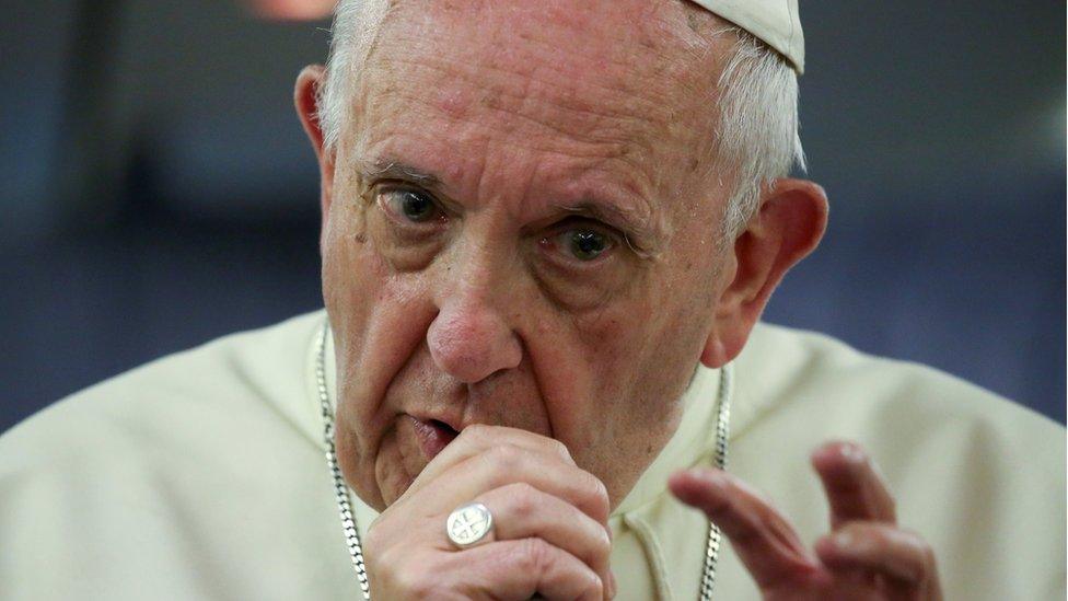 Pope Francis gestures during a news conference on board of the plane during his flight back from a trip to Chile and Peru